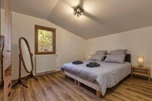 a bedroom with a large bed and a mirror at Chalet Le Grepon - Happy Rentals in Chamonix-Mont-Blanc
