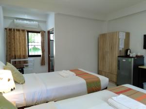 a hotel room with two beds and a kitchen at Rena House Chiang Mai in Chiang Mai