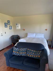 a bedroom with a bed and a couch in it at D'Archiac Studio in Lake Tekapo