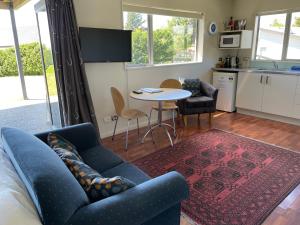 a living room with a couch and a table at D'Archiac Studio in Lake Tekapo