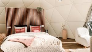 a bedroom with a large bed and a chair at Romantische glamping dome Koksijde - Duiniek in Koksijde