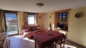 a room with a table and a couch and a table and chairs at Casa Vacanze: Maison Des Gnomes in Challand Saint Anselme