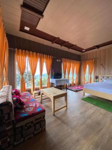 a bedroom with a bed and a table and a piano at JAYANTI MOTHER NATURE HOMESTAY MUNSYARI in Munsyari