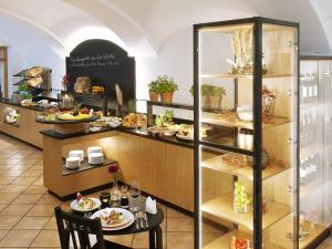 a restaurant with a table and shelves with food at Hotel Restaurant Zum Goldenen Anker mit Hallenbad & Wellnessbereich in Windorf +52 photos