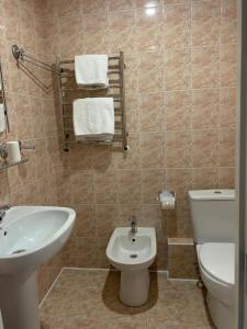 a bathroom with a white toilet and a sink at Візит in Bila Tserkva