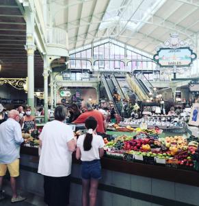 a group of people standing at a fruit market at Les Pins - 3 pièces - Vue sur piscine - 600m mer - Les Sables d'Olonne in Les Sables-dʼOlonne
