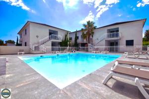 a swimming pool in front of a building at Residence Marea Resort in Santa-Lucia-di-Moriani