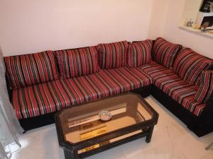 a red couch in a living room with a coffee table at résidence les jardins in El Aouina
