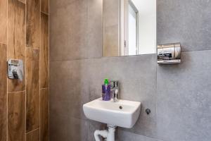 a bathroom with a sink and a mirror at Green Garden !svitlo postiyno! in Lviv