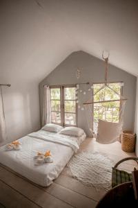 a bedroom with a bed with a hammock in it at Cozy Huts in Trat
