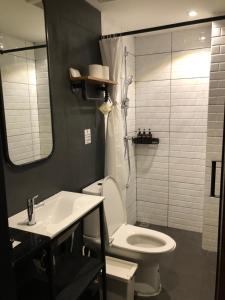 
a bathroom with a toilet, sink, and mirror at P2 Wood Loft in Phi Phi Don
