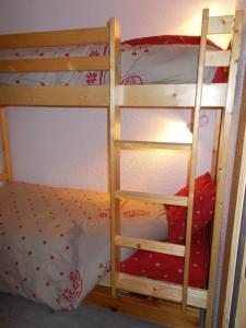 two bunk beds with a ladder in a bedroom at val thorens appartement 4 personnes ski aux pieds in Val Thorens +5 photos