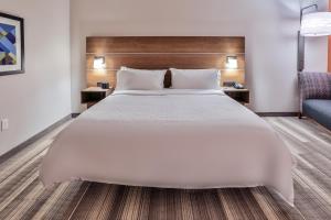 a large white bed in a hotel room at Holiday Inn Express & Suites - Nashville MetroCenter Downtown by IHG in Nashville