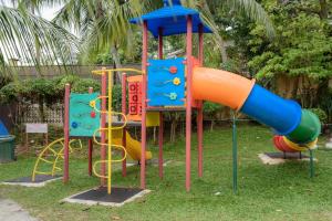 a group of colorful playground equipment in a park at J Beach Suites At Rainbow Paradise in Tanjung Bungah