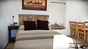 A bed or beds in a room at Alojamiento Rural Tetuán