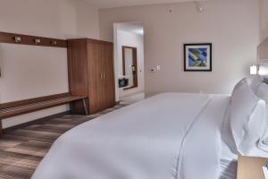 a large white bed in a hotel room at Holiday Inn Express & Suites - Nashville MetroCenter Downtown by IHG in Nashville +86 photos