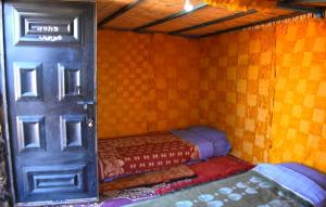 A bed or beds in a room at Tikida Camp by tinfou