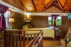 a bedroom with a bed in a room with wooden ceilings at Las del Tatu in El Bolsón