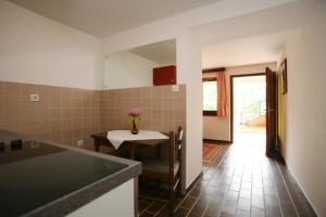 a kitchen with a table and a dining room at Apartments Neda - Poreč South in Poreč