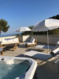 a swimming pool with two umbrellas and chairs and a swimming pool at Eze Villa in Èze