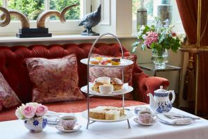 a tray of pastries and cakes on a table at Macdonald Bath Spa Hotel in Bath