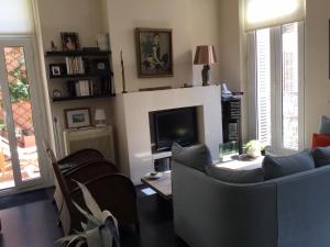 a living room with two couches and a tv at Chambre 1 personne avec terrasse centre ville Marseille 3 nuits min , femme uniquement in Marseille