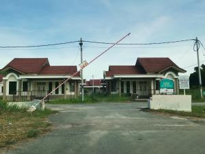 a house with a street sign in front of it at Homestay Pasir Tumboh Kota Bharu in Kota Bharu