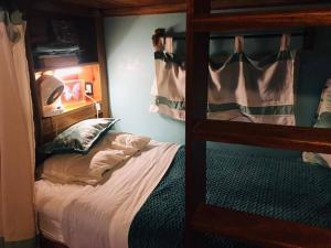 a bedroom with a bunk bed and a bed with a pillow at Turtles Nest Bunkhouse at Lodge at Long Bay in Corn Islands
