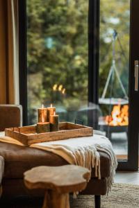 a table with candles on it with a window at LODGE7 by Woods Lodge in Seefeld in Tirol