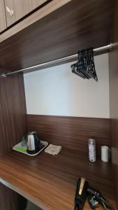 a wooden shelf with utensils on top of it at Aeropod KK Corner Unit Near City and Airport 4 pax Free Parking in Kota Kinabalu