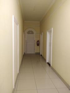 an empty hallway with a door and a tile floor at Lisokhanya GuestHouse in East London