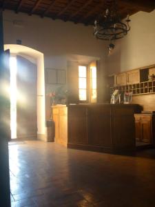 a kitchen with wooden cabinets and a chandelier at Villa Morghen in Settignano