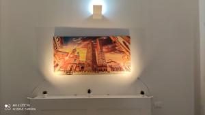a painting on a wall with a light on it at CASA SAVENA in Bologna