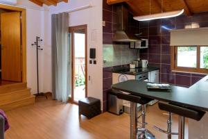 a kitchen with a counter top in a room at Casa da Fonte Gerês in Campo do Gerês +115 photos