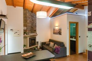 a living room with a couch and a fireplace at Casa da Fonte Gerês in Campo do Gerês