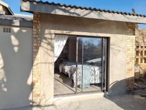 a room with a glass door leading to a patio at THE SPARE BEDROOM Unit 2 in Harrismith