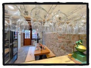 a room with many wine glasses hanging from the ceiling at Chambres d'Hôtes Maison E.Bernat in Saint-Jean-Pied-de-Port