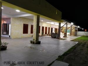 an empty parking lot in front of a building at night at Mersing Maple Villa in Mersing