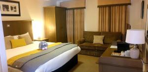 a hotel room with a bed and a couch at Garth Hotel in Grantown on Spey