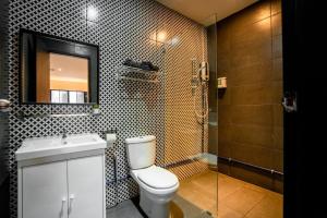 a bathroom with a toilet and a shower with a mirror at Chulia Heritage Studio in George Town