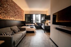 a bedroom with a couch and a bed in a room at Chulia Heritage Studio in George Town