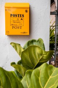 a yellow box on a wall with a plant at Chulia Heritage Studio in George Town