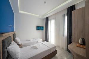 A bed or beds in a room at Okda Hotel