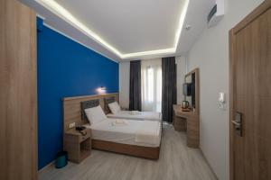 A bed or beds in a room at Okda Hotel