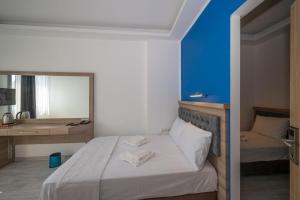 A bed or beds in a room at Okda Hotel