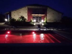 a building at night with a pool of red liquid at exceptionnel loft style industriel tout équipé 15 personnes avec jacuzzi in Villebramar