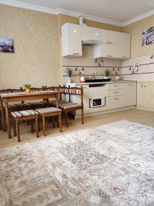a kitchen with a table and chairs in a room at Уютная квартира с панорамой города in Odesa