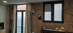 A television and/or entertainment centre at Casas da Bríxida. Primeiro