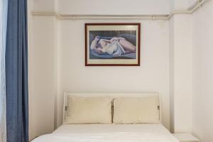 a bedroom with a bed and a painting on the wall at Altiyol Boga, Center of Kadıköy in Istanbul