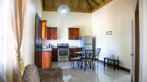 a kitchen and living room with a table and chairs at Ocean View Terrace in Montego Bay